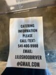 Lilos BBQ catering information sign with phone number and email in Hood River