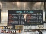 Pelinti Pizza specialty pizzas menu board in Hood River
