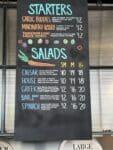 Pelinti Pizza starters and salads menu board in Hood River