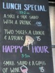 Pelinti Pizza lunch specials and happy hour board in Hood River with pizza, salads, drinks, and wine