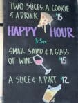 Pelinti Pizza lunch special sign with pizza slices, cookie, and drink in Hood River